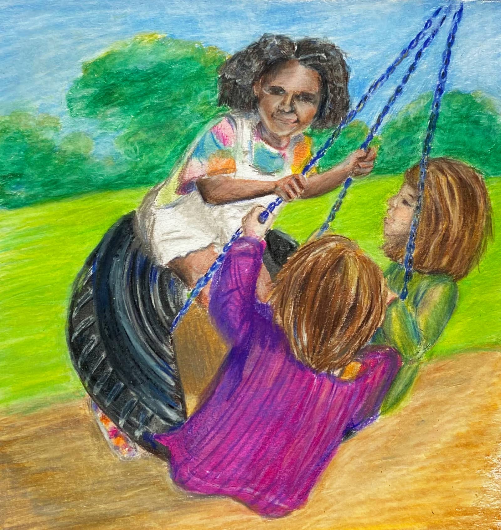 Three girls swing on a tire swing
